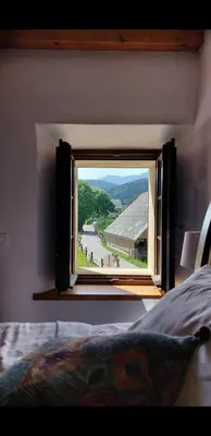a window in a bedroom with a view of a river at Escape to Bohinj House in Bohinj