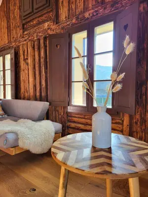 a room with a table and a vase with flowers on it at Escape to Bohinj House in Bohinj