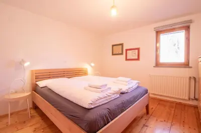 a bedroom with a bed with two towels on it at River Valley View House in Bohinjska Bistrica