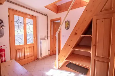 a staircase in a small room with a wooden door at River Valley View House in Bohinjska Bistrica