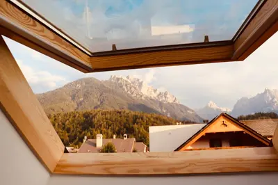 a view from a window in a house with mountains at Sport & Sunny Cosy Alpine Retreat in Kranjska Gora