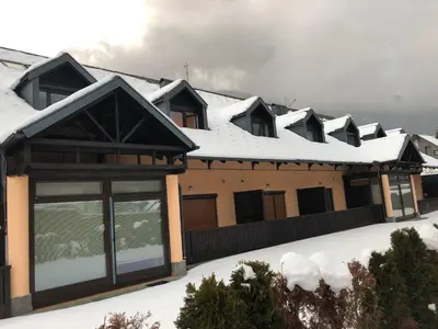 a row of houses with snow on the roofs at Sport & Sunny Cosy Alpine Retreat in Kranjska Gora
