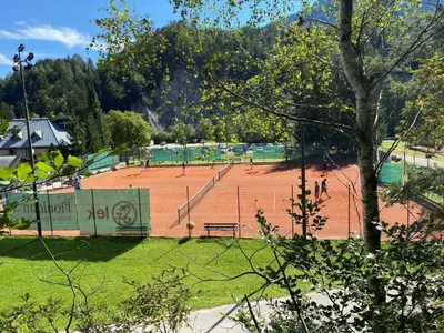 a tennis court in a park with people on it at Sport & Sunny Cosy Alpine Retreat in Kranjska Gora