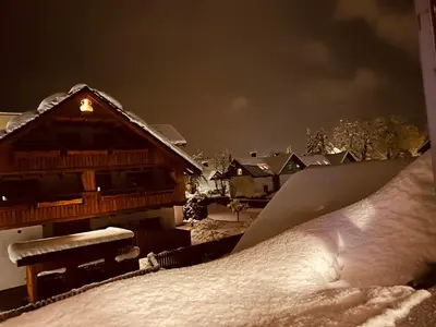 a house with a pile of snow in front of it at Sport & Sunny Cosy Alpine Retreat in Kranjska Gora
