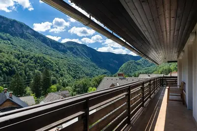 a balcony of a house with a view of mountains at Iglica Apartments - First Floor in Bohinjska Bela