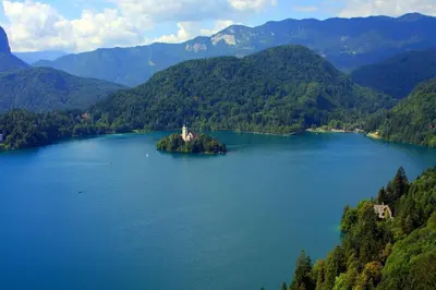 an island in the middle of a large lake at Iglica Apartments - First Floor in Bohinjska Bela