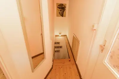 a hallway with a mirror and a stair case at Little Vista in Kojsko