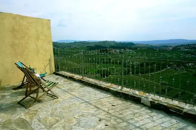 a pair of chairs sitting on a balcony with a view at Little Vista in Kojsko