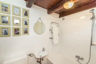 a bathroom with a sink and a toilet and a mirror at Little Vista in Kojsko