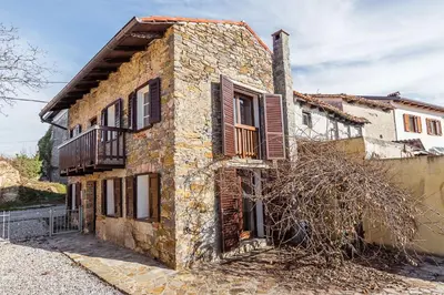 an old brick building with a balcony on the side at Little Vista in Kojsko