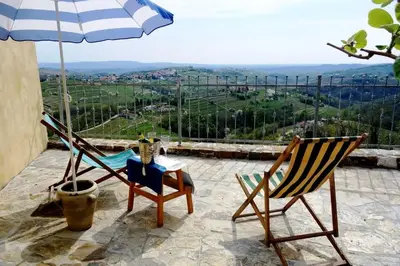two chairs and a table and an umbrella on a patio at Little Vista in Kojsko