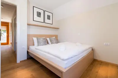 a bedroom with a large white bed in a room at Mostnica Cottage in Bohinj