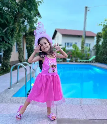 a little girl in a pink dress and a crown at APARTMAN MURKO S-1 in Brest