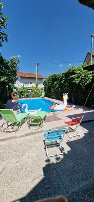 a group of lawn chairs next to a swimming pool at APARTMAN MURKO S-1 in Brest