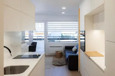 a kitchen and living room with a couch and a sink at Relax Studio Kranjska Gora in Kranjska Gora