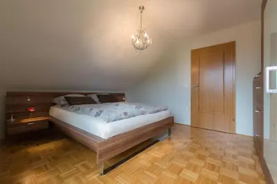 a bedroom with a bed and a chandelier at Sava View 8 in Ribno