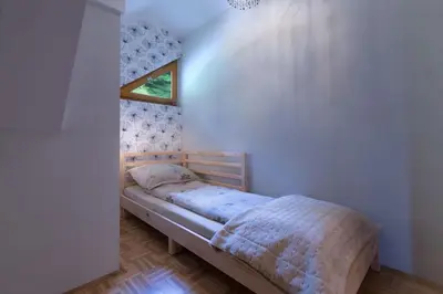 a bedroom with a bed in a room with a window at Sava View 8 in Ribno