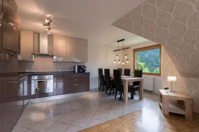 a kitchen with a table and chairs and a dining room at Sava View 8 in Ribno
