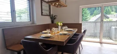 a dining room with a wooden table and chairs at Family house Kranjska Gora in Kranjska Gora