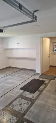 an empty room with a door and a rug at Family house Kranjska Gora in Kranjska Gora