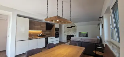a kitchen and dining room with a wooden table at Family house Kranjska Gora in Kranjska Gora