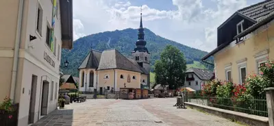 an empty street in a town with a church at Family house Kranjska Gora in Kranjska Gora