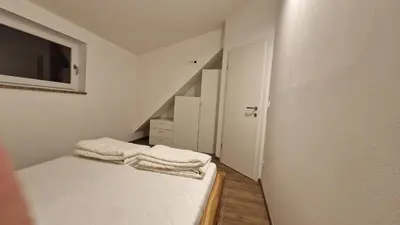 a small bedroom with a bed with towels on it at Family house Kranjska Gora in Kranjska Gora
