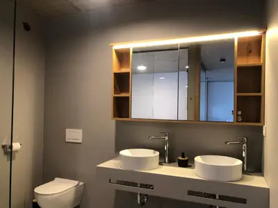 a bathroom with two sinks and a toilet at Holiday House Šmuc in Kranjska Gora