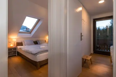 a small bedroom with a bed and a window at Villa Frida in Bohinj
