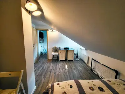 a bedroom with a bed and a desk in a room at Apartment Soul with Free Parking in Kranjska Gora