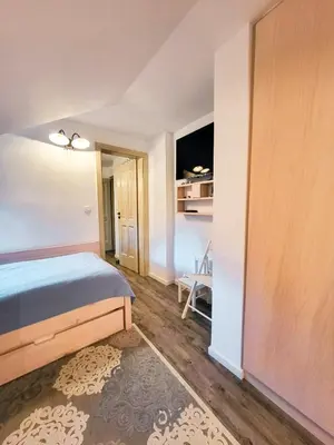 a bedroom with a bed and a room with a closet at Apartment Soul with Free Parking in Kranjska Gora