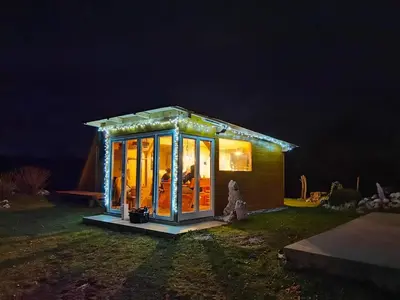 a small house with lights on it at night at Apartma Humar in Kobarid