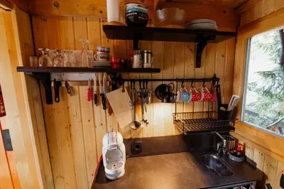 a kitchen with a counter and a sink in a room at Tree House Alpinka Krvavec in Cerklje na Gorenjskem