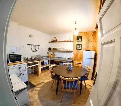 a kitchen and dining room with a table and chairs at Alpine Home - Rooms in Kranjska Gora