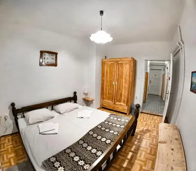a bedroom with a large bed and a wooden floor at Alpine Home - Rooms in Kranjska Gora