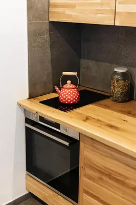 a tea kettle sitting on top of a stove in a kitchen at Alpine Cottage Golica in Jesenice