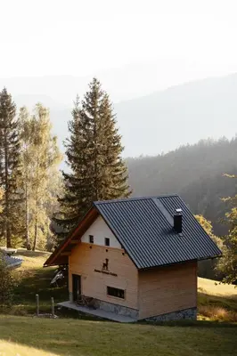 a house with a solar roof on a field at Alpine Cottage Golica in Jesenice