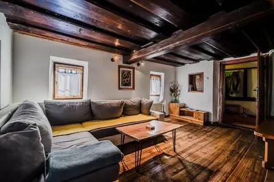 a living room with a couch and a table at Traditional Slovenian House Pr'Belej in Zgornje Gorje