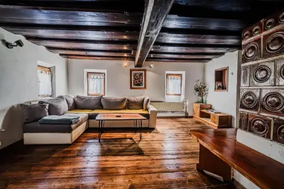 a living room with a couch and a table at Traditional Slovenian House Pr'Belej in Zgornje Gorje