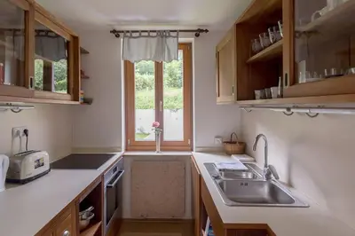 a kitchen with a sink and a window at Private green getaway in Bled