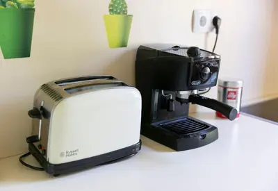a coffee maker and a toaster on a counter at Private green getaway in Bled
