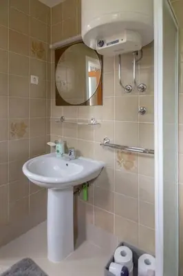 a bathroom with a sink and a mirror at Private green getaway in Bled