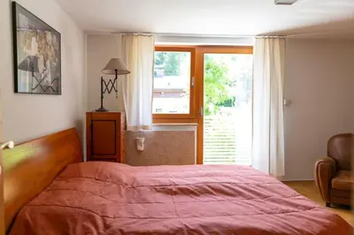 a bedroom with a large bed and a window at Private green getaway in Bled