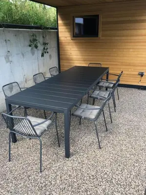 a black table and chairs sitting around a black table and chairs at Private green getaway in Bled