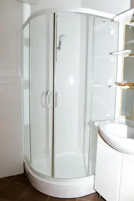 a glass shower in a bathroom with a sink at Miadora apartments - Apartma Idina in Moravske Toplice