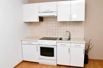 a kitchen with white cabinets and a sink at Miadora apartments - Apartma Idina in Moravske Toplice