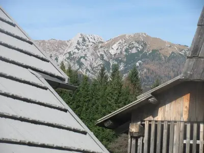 a view of a mountain range from a house at Apartma Hodnik Bohinj Uskovnica in Srednja Vas v Bohinju