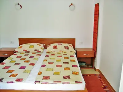 a bed with two pillows on it in a bedroom at Apartma Gorjan in Tolmin