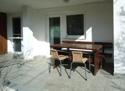 a wooden table and chairs on a patio at Apartma Gorjan in Tolmin
