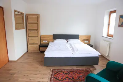a bedroom with a bed in a room with a rug at Apartments Katrca Bežigrad in Ljubljana